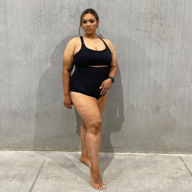 Woman in black two-piece athletic outfit showcasing Emama High Waist Body Shapewear Brief